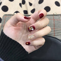 Burgundy Star Shell glossy celestial press-on nails